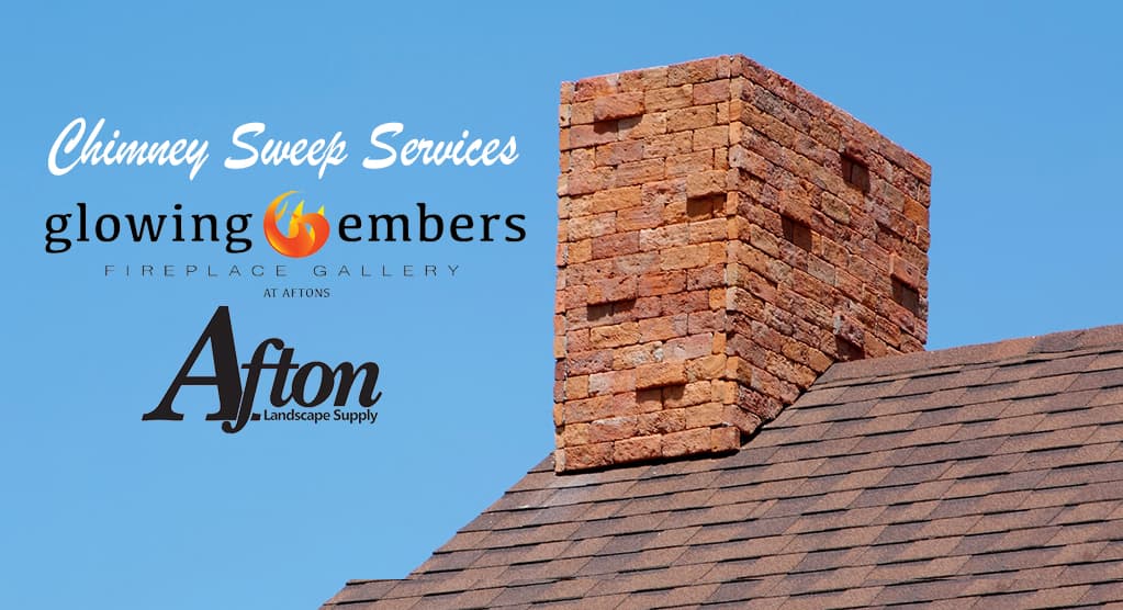 Professional chimney sweep cleaning a brick chimney