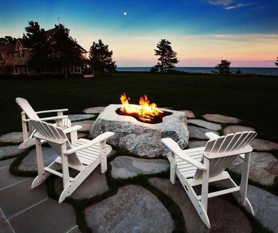 Warming Trends Crossfire burner in a natural stone firepit