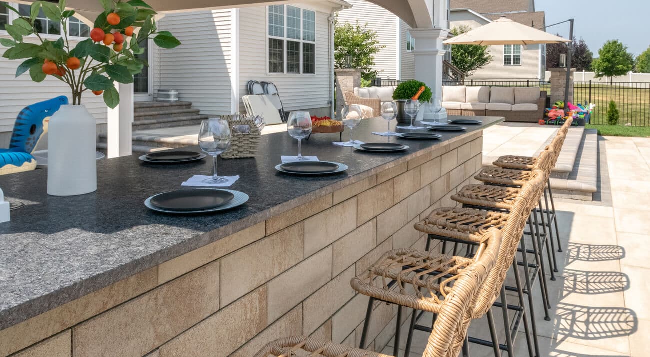 Outdoor kitchen bar with seating and dining setup